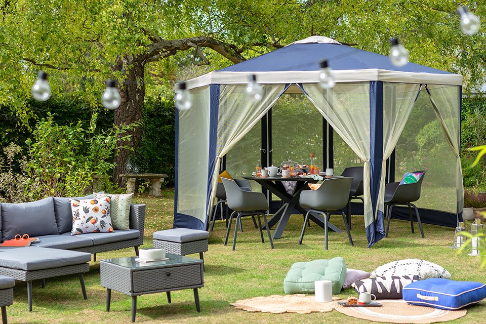 A gazebo popped open in a garden.